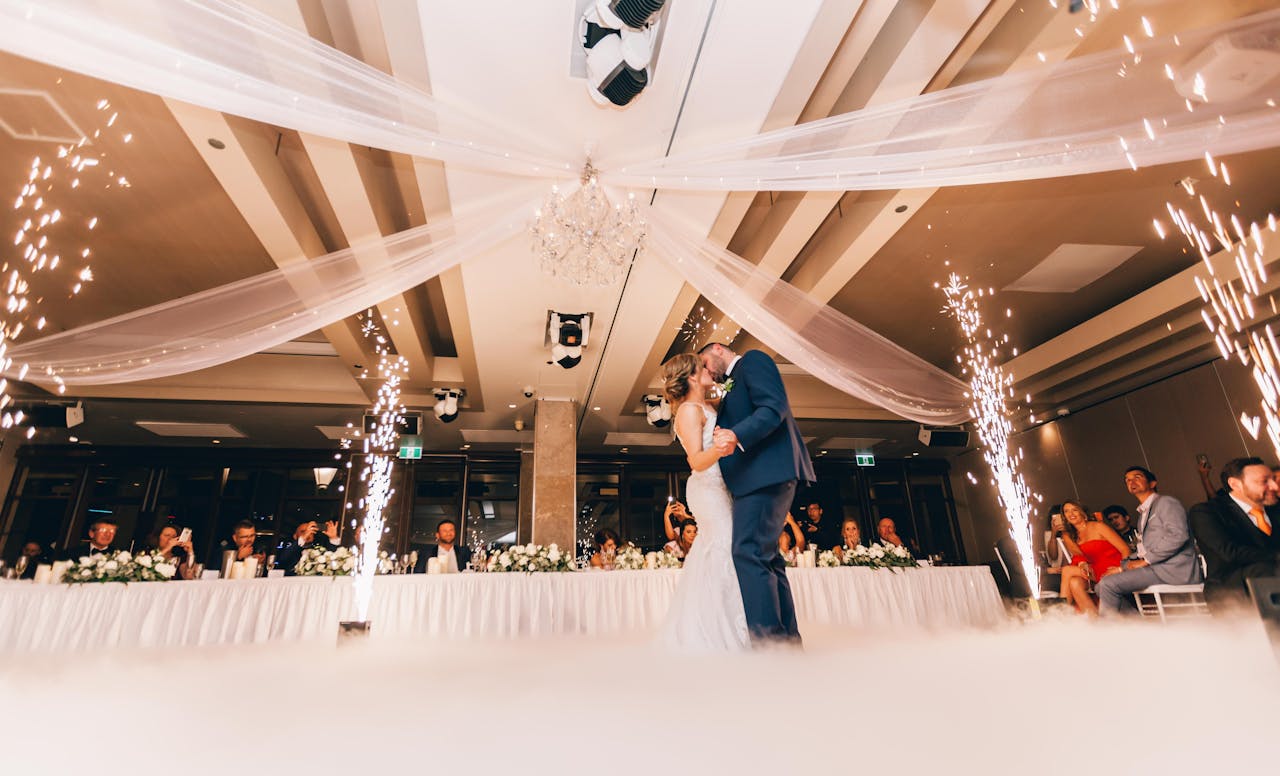 Romantic bride and groom dance surrounded by sparklers at a luxurious Sydney wedding reception.